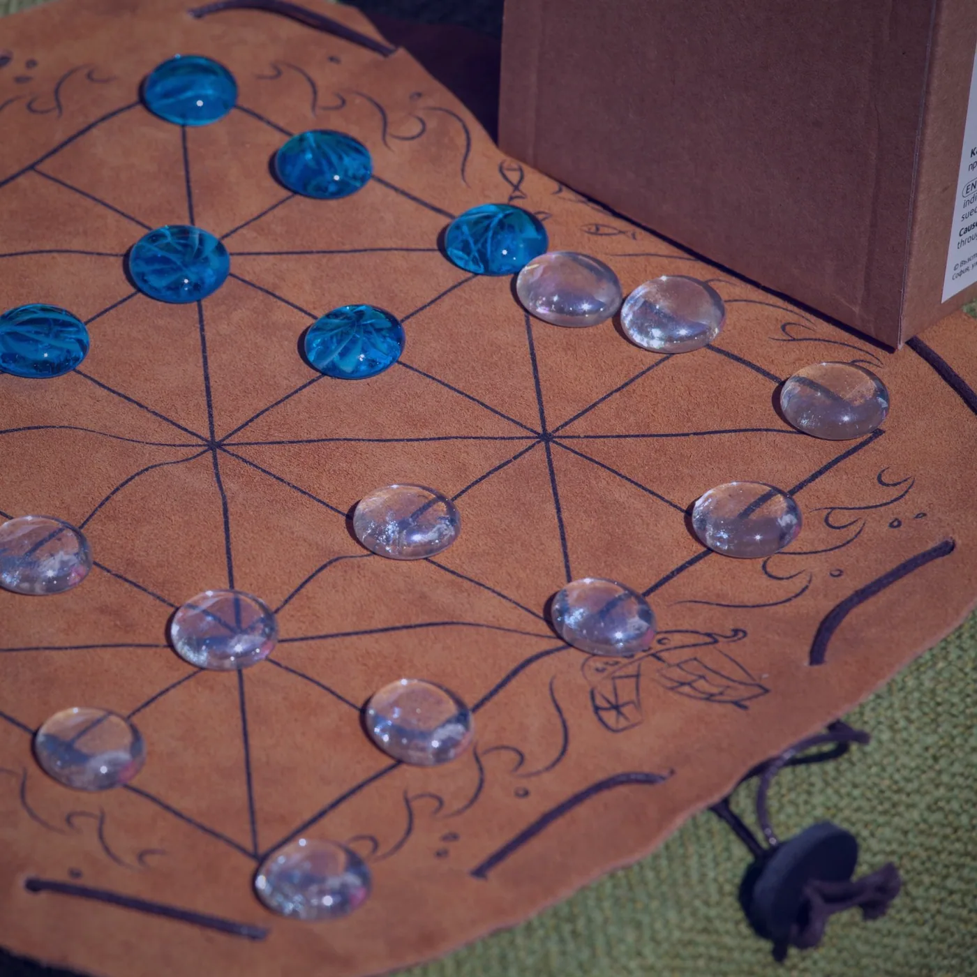 Miniatures arranged on a table beside a rulebook